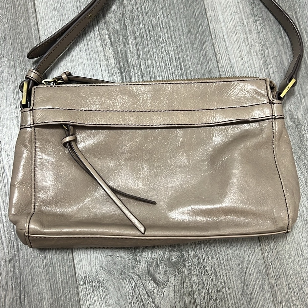 Hobo taupe gray brown leather crossbody bag with a taupe fossil small wallet.